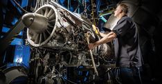 a man is working on an airplane engine