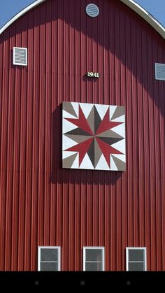 a red barn with a white and grey star on it