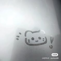 an image of a hello kitty drawn on the window with water droplets in front of it