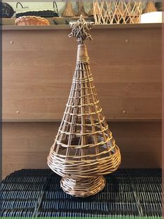 a wicker christmas tree sitting on top of a table