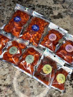 several bags of food sitting on top of a counter next to each other with writing on them