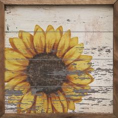 a painting of a sunflower on an old white painted wood planks with paint chipping