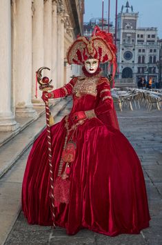 This striking clear image of a female participant in the Venice Carnival is posing for the camera to reveal her beautiful eyes inside the ornate, hand painted traditional mask.  Venice Carnival happens once a year before Easter and lasts two weeks. I have photographed this unique event twice so far and I want to return to do it again. Venice is both classic and romantic and the variance in Venetian costumes makes each carnival unique.  People from all over the world come to attend and most participate even if it involves wearing only a small mask.  The costumes cost in the thousands of dollars and on some nights, large balls are filled with costumed revelers who are donned in glorious fabric, vintage dress shoes, hand painted masks and elaborate wigs. As a photographer, I am constantly see Artistic Red Masks And Prosthetics For Costume, Traditional Red Costume Masks And Prosthetics, Traditional Red Masks And Prosthetics For Costume, Traditional Red Masks And Prosthetics For Costume Party, Traditional Masquerade Mask For Carnival, Traditional Mardi Gras Costume Masks And Prosthetics, Traditional Carnival Masks And Prosthetics, Traditional Masks And Prosthetics For Theater Festivals, Traditional Theater Masks And Prosthetics For Festivals