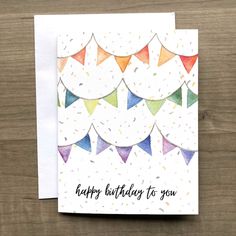 a happy birthday card with colorful confetti on white paper and the words, happy birthday to you