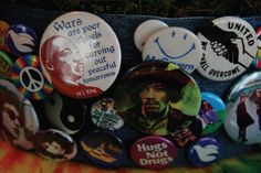 many buttons have been placed on the back of a denim bag, which is decorated with images of bob marley