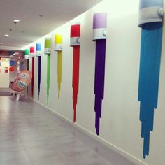 an empty hallway with colorful paint on the walls