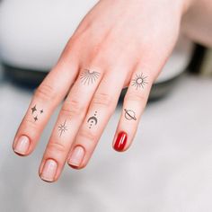 a woman's hand with three different tattoos on her fingers and one has a red manicure