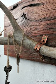 a close up of an old key on a wooden wall with two keys attached to it