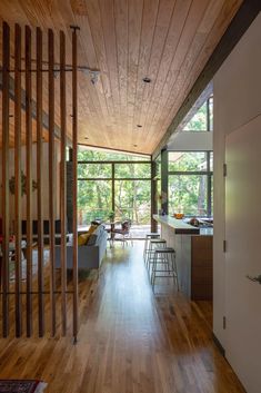 an open kitchen and living room with wood flooring on both sides of the room