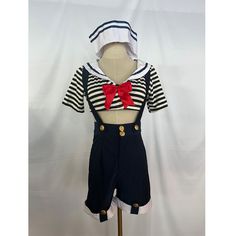 a mannequin dressed in sailor outfit with red bow