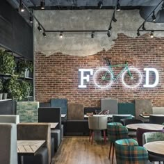 a restaurant with brick walls and tables, chairs, and bikes on the wall behind them