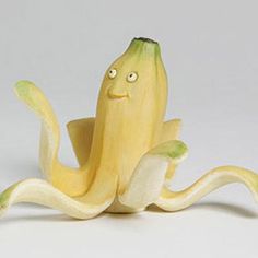 a banana with eyes and arms sitting on top of it's side, looking like an octopus