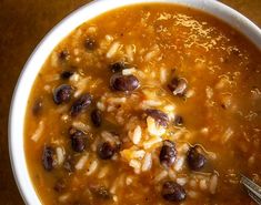 a white bowl filled with beans and rice