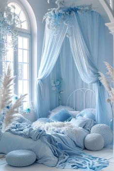 a bedroom with blue and white decor on the walls, windows, and bedding