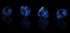 three different types of blue diamonds on a black background with reflection in the dark room