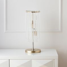 a white table with a lamp on top of it