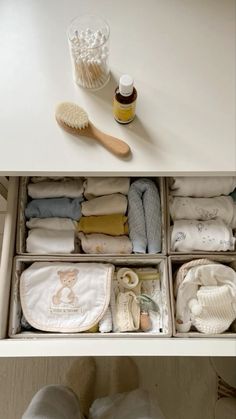 an open drawer with baby items in it