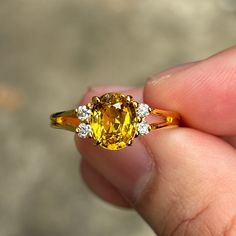 A stunning antique ring with Natural beryllium treated Yellow Sapphire (Certified - it's beryllium treated)  and Natural Diamonds on the Gold setting. The Yellow Sapphire has very nice color and clarity and the diamonds are very shining. it's very beautiful! -Second-hand- I think it's from around 20-30 years ago but I am not sure of the precise date. It's in very good condition - I have already re-polished the ring. Metal Type: 18k Gold Total Weight: 3.403 grams Dimensions: 11.47 mm. (From left to right) x 8.20 mm. (from top to bottom)  thinnest part of the band is 0.7 mm. (I put the dimensions of the ring in the last picture of this listing, Please check) Ring Size: 7 3/4 US (adjustable - Please feel free to contact me)   Center Gemstone and Accent Diamonds Gemstone: Natural Yellow Sapphi Yellow Oval Sapphire Diamond Ring, Oval Yellow Sapphire Ring With Diamonds, Yellow Oval Sapphire Ring With Prong Setting, Classic Yellow Sapphire Diamond Ring, Exquisite Yellow Ring With Prong Setting, Exquisite Yellow Rings With Prong Setting, Classic Yellow Sapphire Ring With Accent Stones, Yellow Sapphire Ring With Vvs Clarity, Yellow Sapphire Ring With Accent Stones