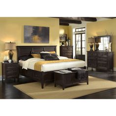 a bedroom scene with focus on the bed, dresser and footboard set's