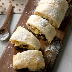 pastries on a cutting board with powdered sugar