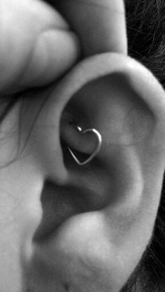 a person with a heart shaped ear piercing on their left side, and the other half of