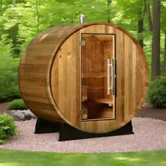 a wooden barrel sauna in the middle of a garden