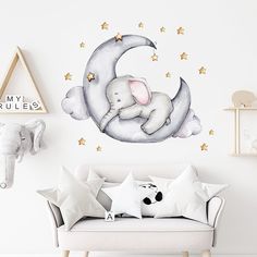 an elephant is sleeping on the moon wall decal in a child's room