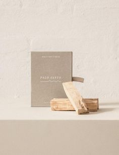 a wooden object sitting on top of a table next to a card board and box