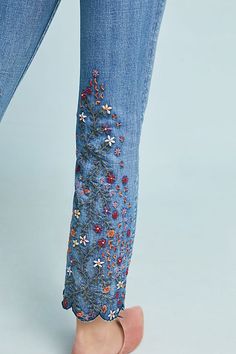 woman's jeans with embroidered flowers on them