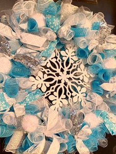 a blue and white wreath with snowflakes on it