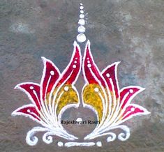 an artistic design is painted on the ground in white and red colors with pearls hanging from it's sides