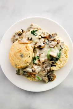 a white plate topped with biscuits and mushrooms