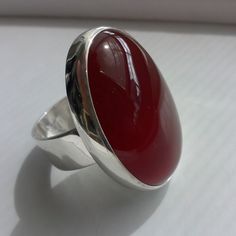 "Carnelian Silver Ring This is a classic ring with a beautiful red Carnelian 30 x 22 mm, settled on Sterling Silver band width 8 mm. Carnelian, in shades of red combines the energy of the pure red ray, and the exuberance and joy of the orange. It is the color of strength and vitality, both physical and spiritual. This ring match with the pendant that you can see in the following link: http://etsy.me/1WOrkQM If you want order the ring and the pendant, ask me for an additional 10 % OFF. *This jewe Red Carnelian Ring With Polished Finish, Red Carnelian Rings With Polished Finish, Red Polished Carnelian Rings, Red Oval Cabochon Ring, Red Carnelian Oval Cabochon Ruby Ring, Oval Red Carnelian Jewelry, Red Oval Cabochon Ring With Polished Finish, Formal Red Carnelian Ring, Red Carnelian Cabochon Ruby Ring