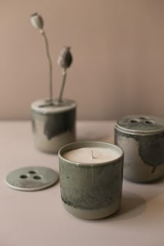 two candles sitting next to each other on a table