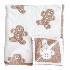 two towels with teddy bears on them, one is brown and the other is white