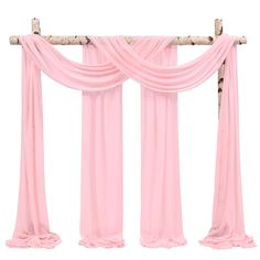 the pink drapes are hanging up on the wall with wood poles and fabric draped over them