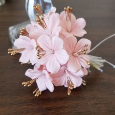 a bouquet of pink flowers sitting on top of a wooden table