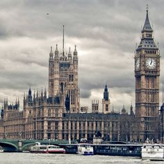 the big ben clock tower towering over the city of london, england as seen from across the thames