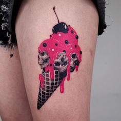 a woman's thigh with an ice cream cone and skulls painted on the side