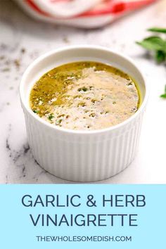 garlic and herb vinaigrette soup in a white bowl on a marble table