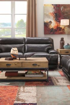 a living room with two couches, a coffee table and a painting on the wall