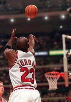 an image of a basketball player jumping up to dunk the ball in the air