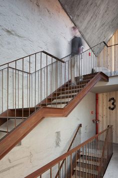 a man riding a skateboard down the side of a stair case