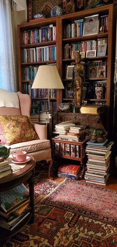 a living room filled with furniture and lots of books on top of a book shelf