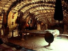 the inside of a hut with many items in it