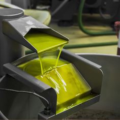 a yellow liquid being poured into a container