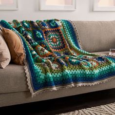 a crocheted granny blanket on a couch