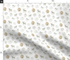 a white fabric with dogs on it and a ruler in front of the image is shown