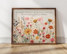 an art piece with flowers and a quote on it