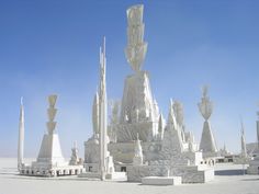 a large white sculpture in the middle of a desert